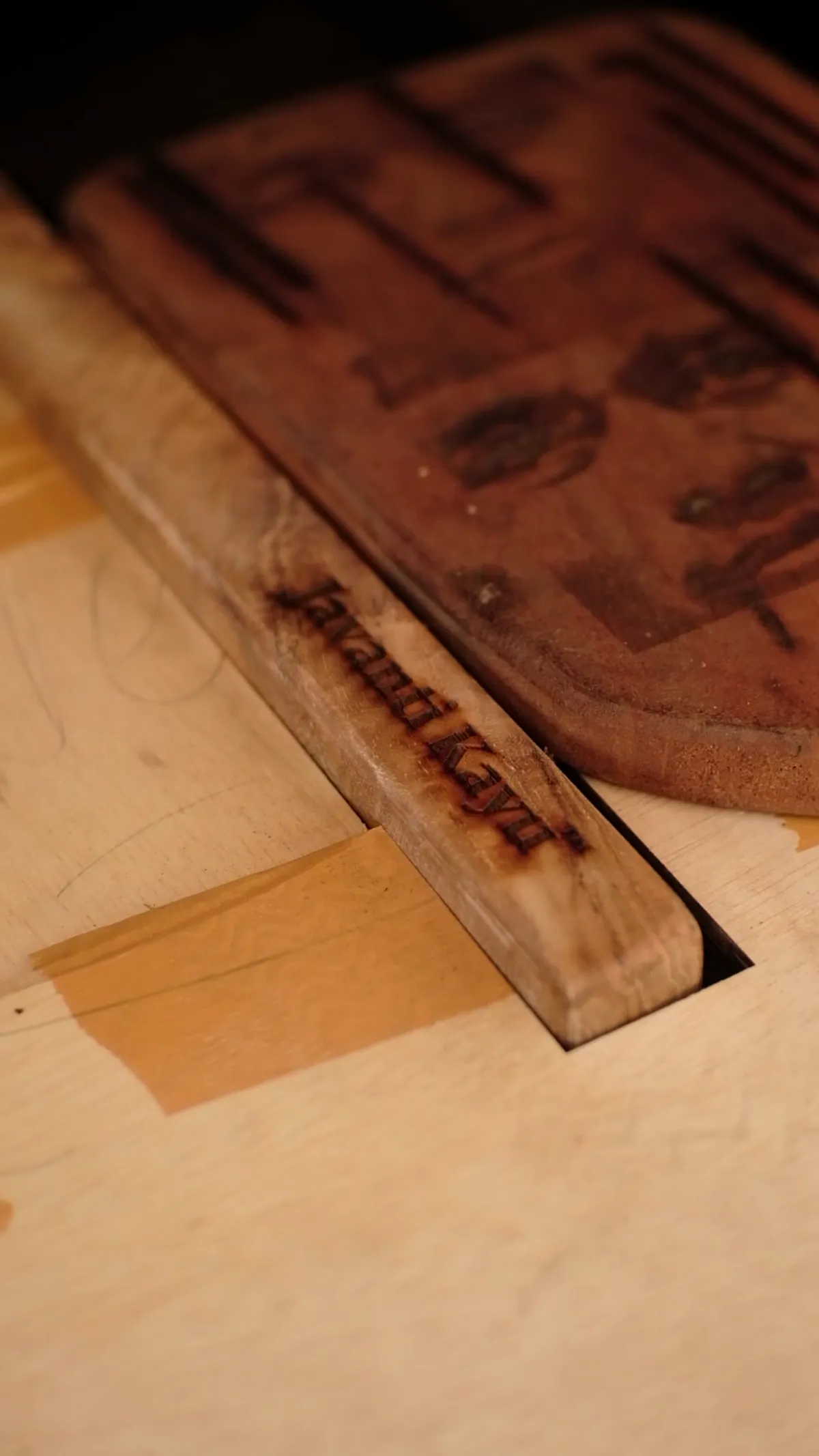 The Javanti mark burned into a board edge